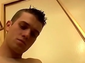 Boy pissing all over his body and wanking his massive dick